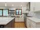 Stylish kitchen with stainless steel appliances, white cabinets, granite countertops, and tiled backsplash at 7426 Shadow Wood Dr, Indianapolis, IN 46254