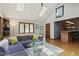 Open living room featuring hardwood floors, a large sectional, and natural light at 7426 Shadow Wood Dr, Indianapolis, IN 46254