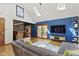 Open living room with a large window, a sliding door, and a bar area at 7426 Shadow Wood Dr, Indianapolis, IN 46254