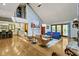 Bright living room with vaulted ceilings, fireplace, hardwood floors, and access to the kitchen and patio at 7426 Shadow Wood Dr, Indianapolis, IN 46254