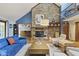 Bright living area featuring hardwood floors, brick fireplace, and open layout design at 7426 Shadow Wood Dr, Indianapolis, IN 46254