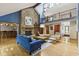 Open-concept living room boasting a brick fireplace, hardwood floors, and second-story overlook at 7426 Shadow Wood Dr, Indianapolis, IN 46254