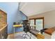 Home office with wood desk, rolling chair and large window overlooking yard at 7426 Shadow Wood Dr, Indianapolis, IN 46254