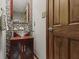 Elegant powder room featuring a glass vessel sink and decorative mirror at 7426 Shadow Wood Dr, Indianapolis, IN 46254