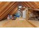 This attic has a wooden floor and wooden walls with a skylight in the middle of the ceiling at 7630 Blain Way, Indianapolis, IN 46254