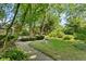 The lush backyard showcases mature trees and landscaping that create a private, tranquil retreat at 7630 Blain Way, Indianapolis, IN 46254