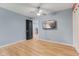 Spacious bedroom features stylish ceiling fan, wood floors and wall-mounted television at 7630 Blain Way, Indianapolis, IN 46254
