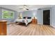 Cozy bedroom with hardwood floors, a ceiling fan, and a view from the bright window at 7630 Blain Way, Indianapolis, IN 46254