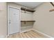 This walk in closet contains shelving, a door to the outside, and hardwood floors at 7630 Blain Way, Indianapolis, IN 46254
