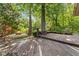 A spacious wooden deck overlooks a serene yard with mature trees, offering an inviting outdoor space for relaxation at 7630 Blain Way, Indianapolis, IN 46254