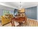 Elegant dining area with stone fireplace and views of the landscaped backyard at 7630 Blain Way, Indianapolis, IN 46254