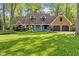Charming two-story home with a well-manicured lawn, blue siding, stone accents, and a three-car garage at 7630 Blain Way, Indianapolis, IN 46254