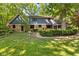 Charming home exterior with stone accents, manicured lawn, and mature trees, exuding classic curb appeal at 7630 Blain Way, Indianapolis, IN 46254