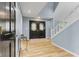 Foyer featuring hardwood floors, black double doors, and a white staircase at 7630 Blain Way, Indianapolis, IN 46254