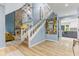 Open foyer with a staircase, stone fireplace, and hardwood floors at 7630 Blain Way, Indianapolis, IN 46254