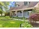 Inviting front entrance with a covered porch, manicured landscaping, and blue wood siding at 7630 Blain Way, Indianapolis, IN 46254
