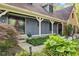 Inviting front entrance with decorative glass doors, manicured landscaping, and blue wood siding at 7630 Blain Way, Indianapolis, IN 46254