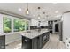 Bright and airy kitchen featuring modern appliances and an eat-in island with decorative lighting at 7630 Blain Way, Indianapolis, IN 46254