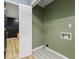 Cozy laundry room offering storage space with open bi-fold door and hookups at 7630 Blain Way, Indianapolis, IN 46254