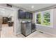 Bright laundry room with modern washer and dryer and window to the backyard at 7630 Blain Way, Indianapolis, IN 46254
