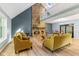 Spacious living room with a stone fireplace, vaulted ceiling, and hardwood floors at 7630 Blain Way, Indianapolis, IN 46254