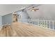 Bright, high ceiling living room with stone accent wall and wooden floors at 7630 Blain Way, Indianapolis, IN 46254