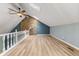 Bright, high ceiling living room with stone accent wall and wooden floors at 7630 Blain Way, Indianapolis, IN 46254