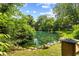 A serene pond surrounded by lush greenery creates a tranquil outdoor oasis and natural beauty at 7630 Blain Way, Indianapolis, IN 46254