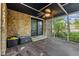 A stone wall complements the screened porch with ceiling fan and outdoor access, creating a relaxing, versatile space at 7630 Blain Way, Indianapolis, IN 46254