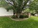 Backyard featuring mature trees, and a wooden deck perfect for outdoor enjoyment at 802 Fern Dr, Shelbyville, IN 46176