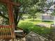 View of grassy backyard featuring trampoline, tree, wood feature and privacy fence at 802 Fern Dr, Shelbyville, IN 46176