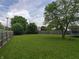 Fenced backyard featuring a trampoline and mature trees at 802 Fern Dr, Shelbyville, IN 46176