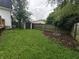 Large backyard featuring a shed, wooden fence and a fire pit area at 802 Fern Dr, Shelbyville, IN 46176