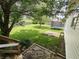 View of grassy backyard featuring trampoline, tree, wood feature and privacy fence at 802 Fern Dr, Shelbyville, IN 46176