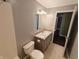 A well-lit bathroom features a toilet, vanity with sink, and neutral wall paint at 802 Fern Dr, Shelbyville, IN 46176