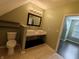 Bathroom with double sinks, fresh paint, and wood-look tile flooring at 802 Fern Dr, Shelbyville, IN 46176