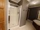 Shower stall, linen closet, neutral floors, and gray walls in a bathroom at 802 Fern Dr, Shelbyville, IN 46176