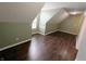 Bright bedroom featuring dark wood floors, fresh paint, and a light fixture at 802 Fern Dr, Shelbyville, IN 46176