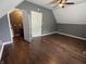 A bedroom has hardwood floors and a white door with neutral walls at 802 Fern Dr, Shelbyville, IN 46176