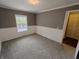 Bedroom featuring gray carpet, white wainscoting, and a window providing natural light at 802 Fern Dr, Shelbyville, IN 46176
