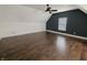 Bedroom features hardwood floors, a ceiling fan, and natural light from the window at 802 Fern Dr, Shelbyville, IN 46176