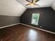 A spacious bedroom with wood floors, a window, and a ceiling fan provides comfort and natural light at 802 Fern Dr, Shelbyville, IN 46176