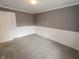 Bedroom featuring gray carpet, white wainscoting, and a window providing natural light at 802 Fern Dr, Shelbyville, IN 46176