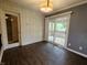 Bright dining area with wood floor, sliding doors to the deck and white wainscoting at 802 Fern Dr, Shelbyville, IN 46176