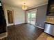 Bright dining area with sliding glass doors to a deck, adjacent to the kitchen at 802 Fern Dr, Shelbyville, IN 46176
