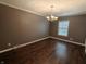 Cozy dining room with hardwood floors, a chandelier, and a large window offering plenty of natural light at 802 Fern Dr, Shelbyville, IN 46176