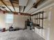 Spacious garage featuring bare walls, exposed ceiling rafters, and a window at 802 Fern Dr, Shelbyville, IN 46176