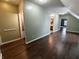 Hallway displaying hardwood floors, access to various rooms, and light fixtures at 802 Fern Dr, Shelbyville, IN 46176