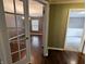 Charming hallway with hardwood floors and glass French doors leading to other rooms in the home at 802 Fern Dr, Shelbyville, IN 46176