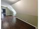 A hallway with hardwood floors leads to multiple rooms with light green colored walls at 802 Fern Dr, Shelbyville, IN 46176